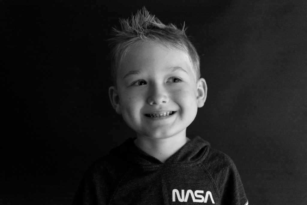 black and white image of boy smiling