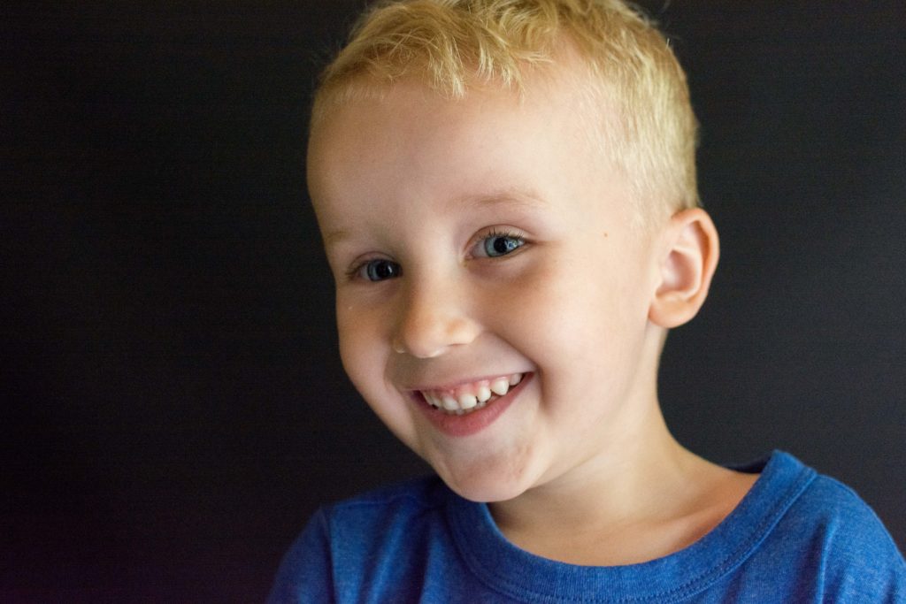 example photo: boy smiling in a blue shirt