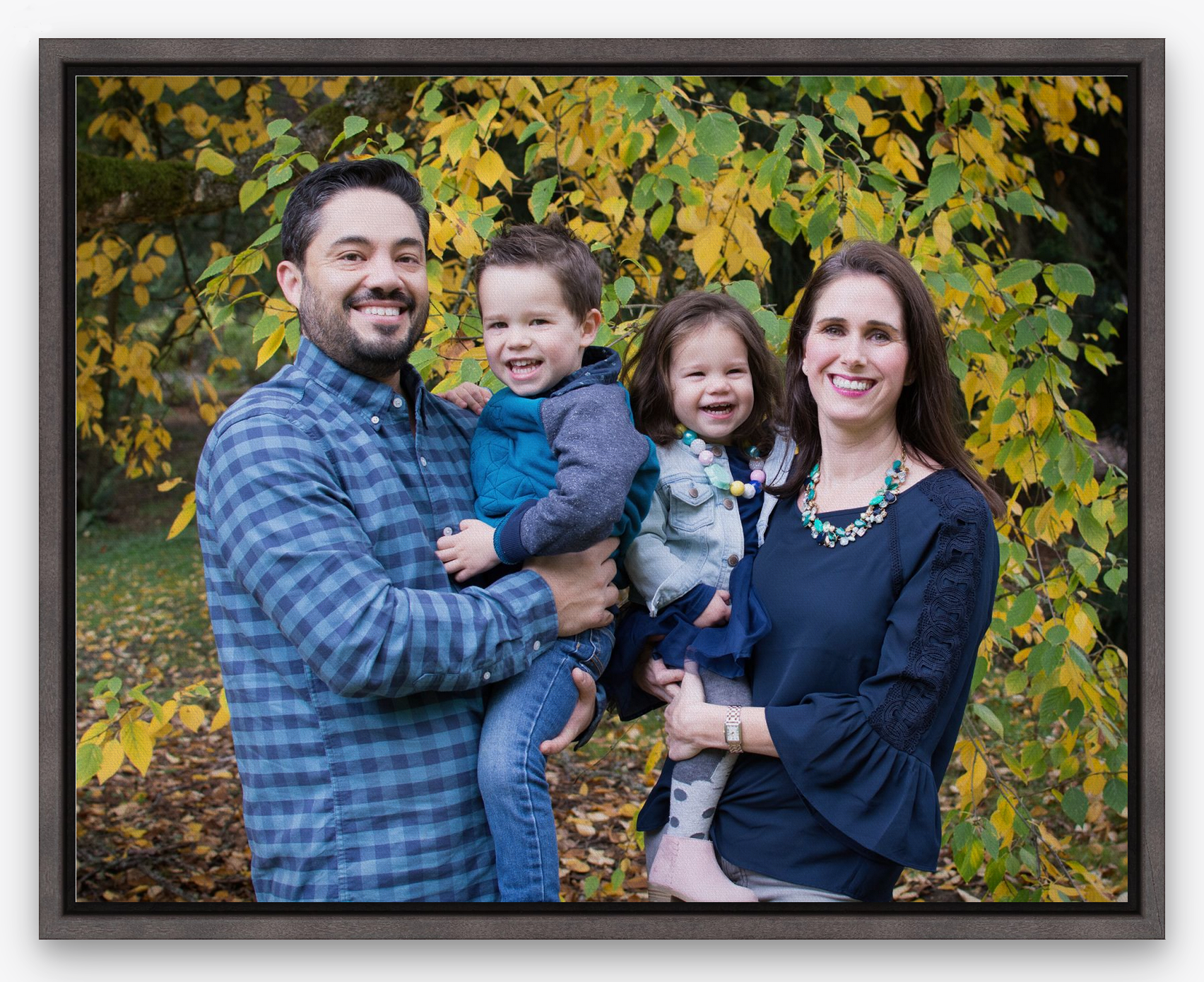 family smiling in a photo in a gallery wrapped canvas with a float frame